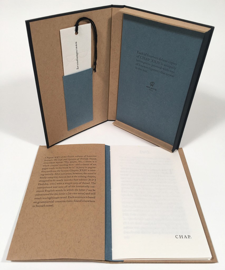 Chapter XXIV open to the title page with the book's enclosure open in the background. 