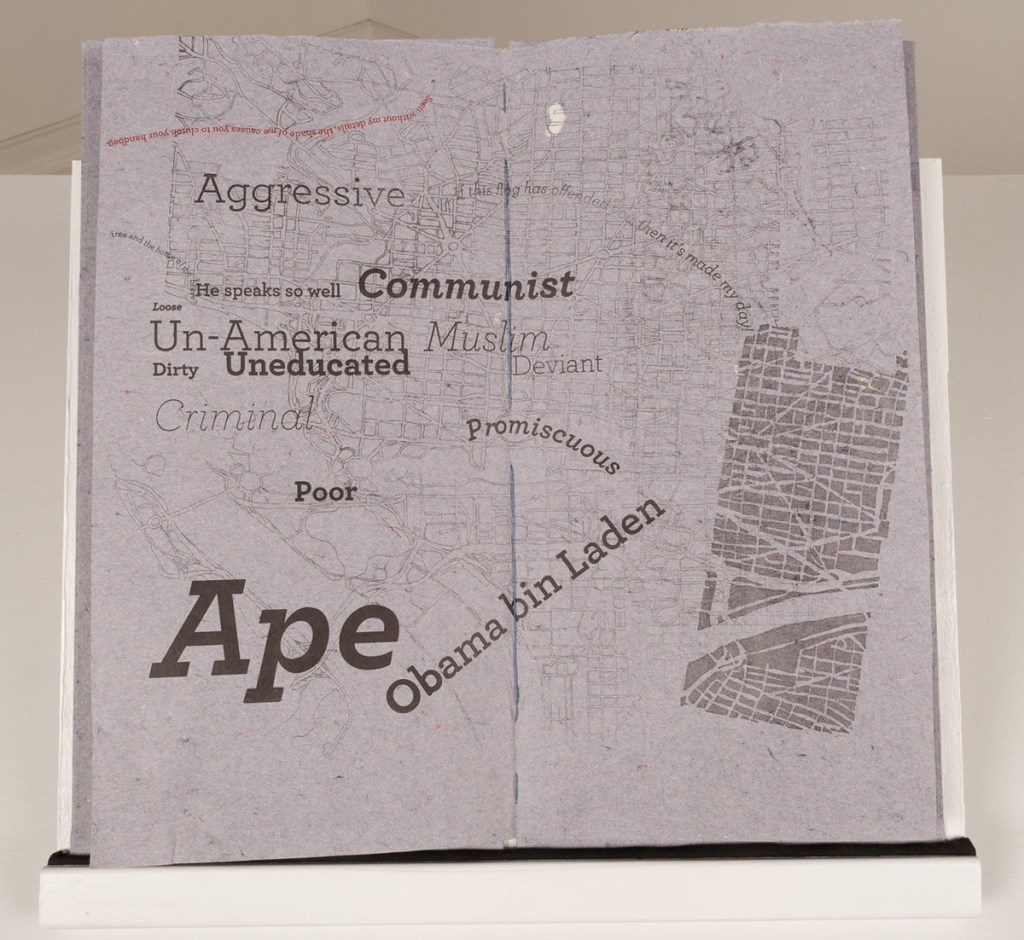 Center spread of "Past PRESENT: DC". Historical maps are overlaid with racial slurs, stereotypes and political insults.  