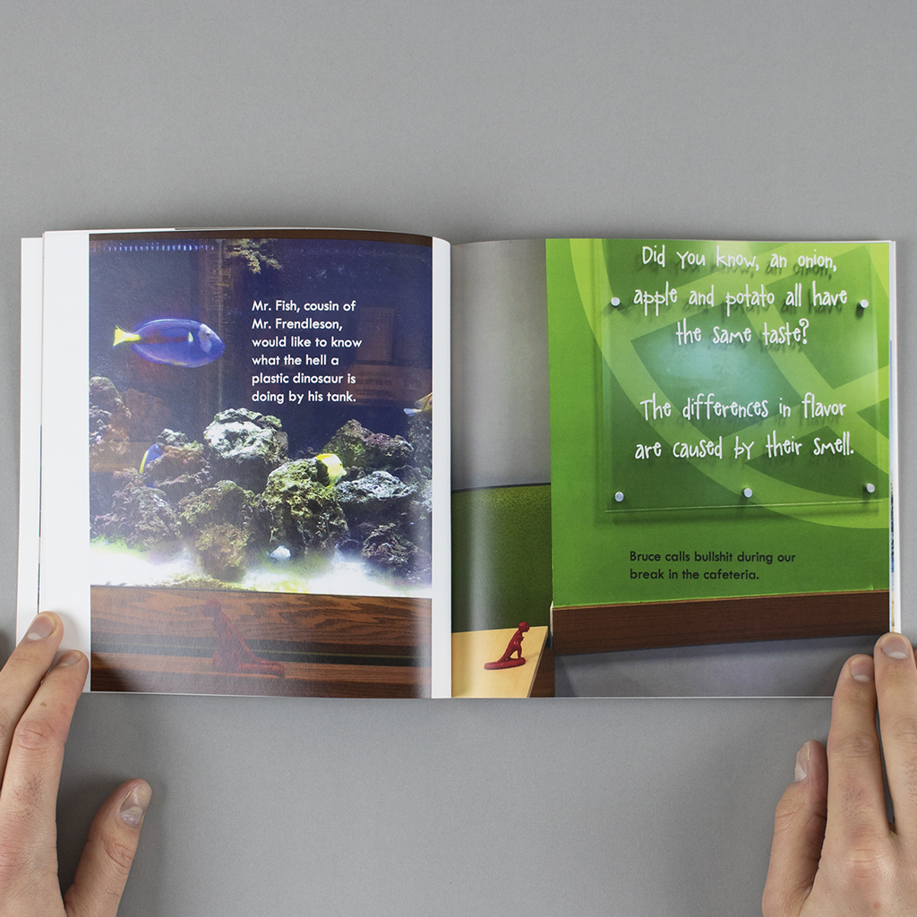 Inside spread; toy dinosaur in front of a live fish, and a questionable sign in the cafeteria