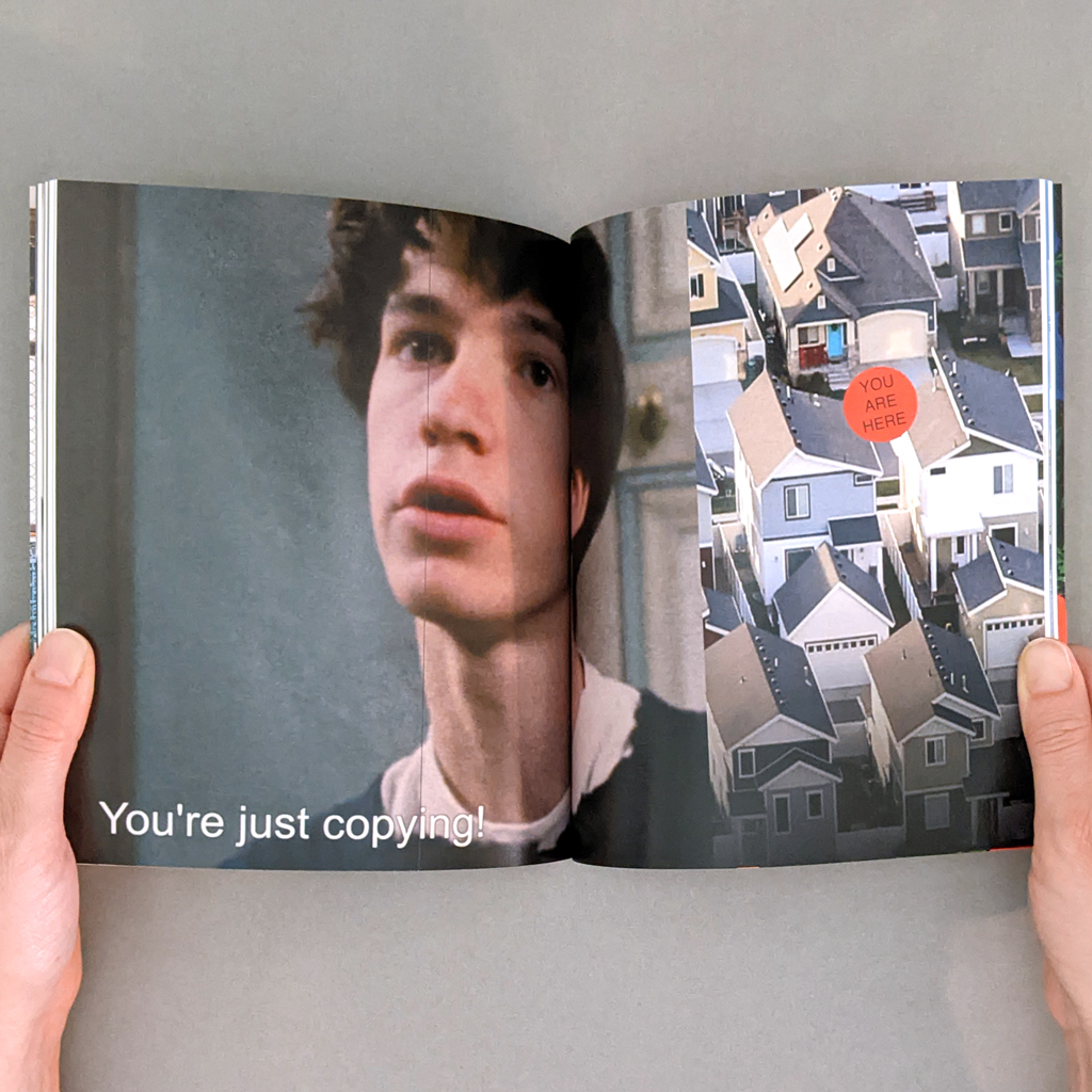Copy No. 1 inside spread. Verso: A screenshot with a closed caption "You're just copying!"; Recto an aerial view of a subdivision with a "you are here" sticker placed between two houses.