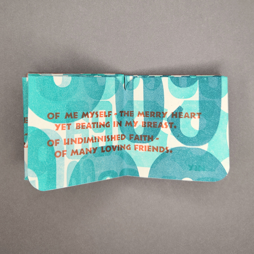 A Carol at Sixty Nine open to a two-page spread, showing the word 'yin' printed subtly in the corner